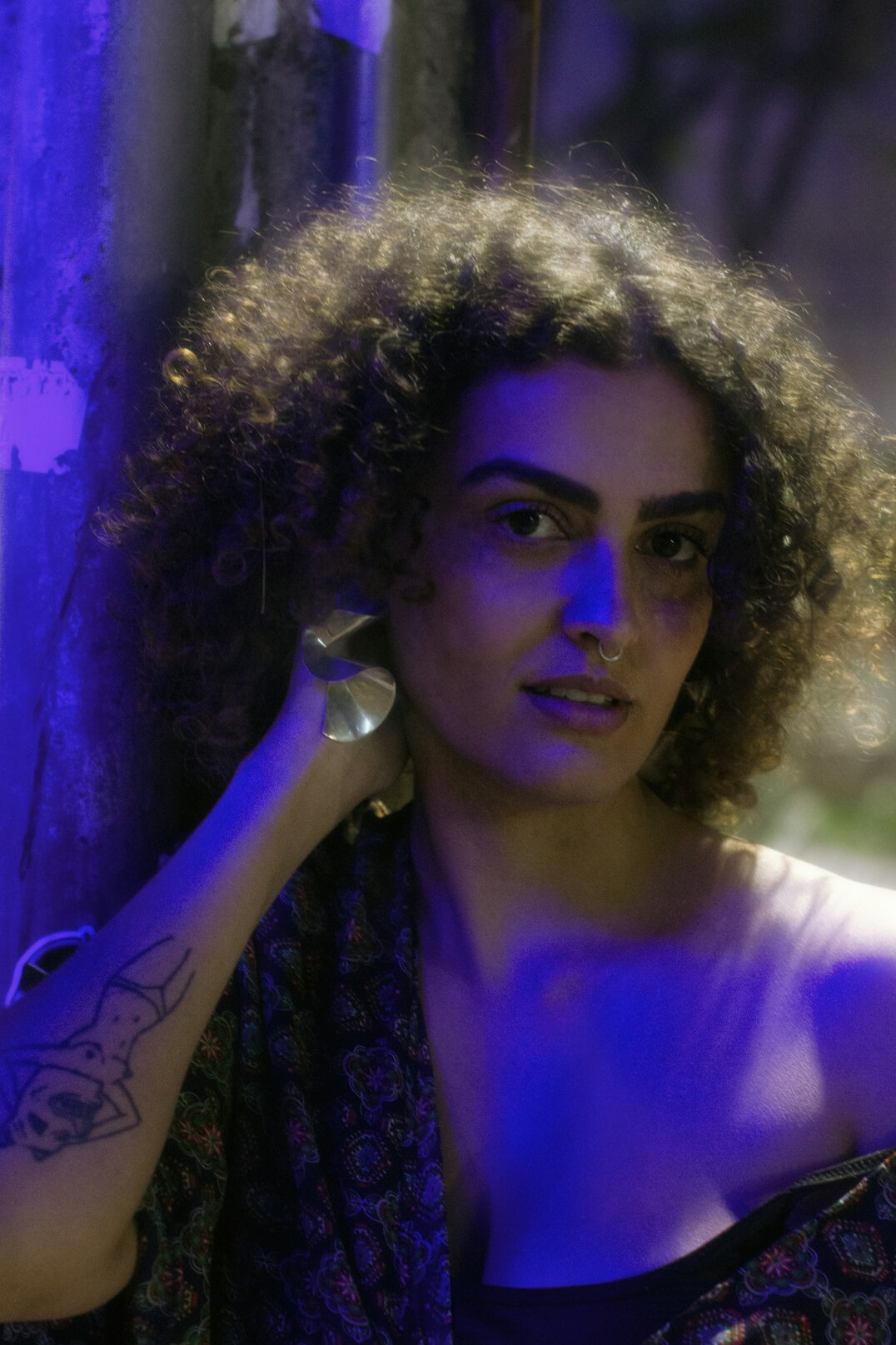 Portrait of a young woman with curly hair smiling